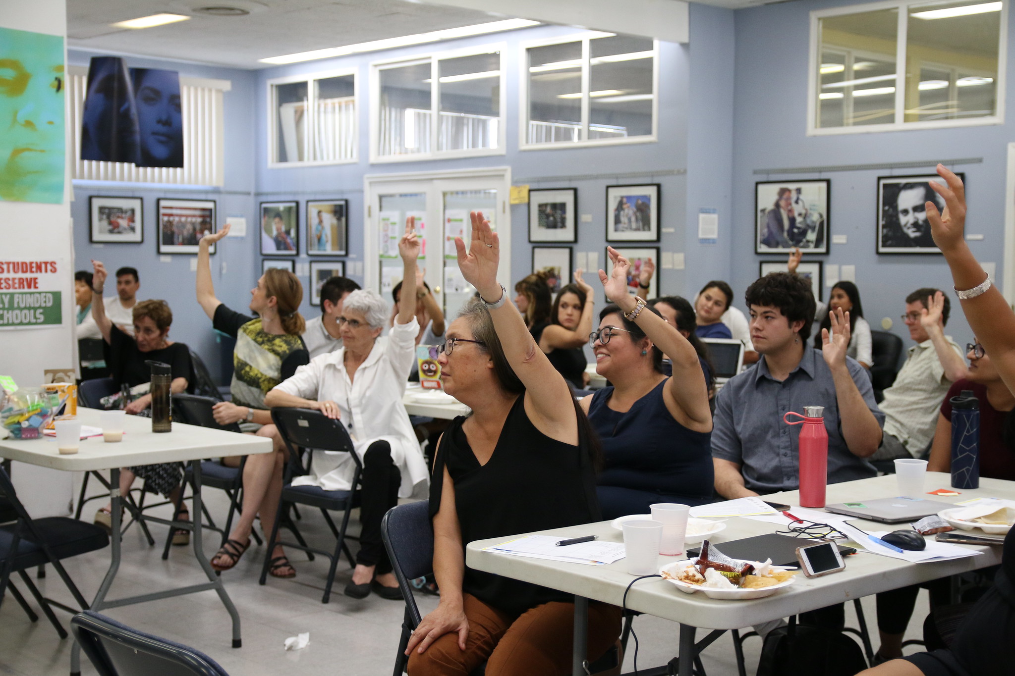 People raising their hand during an event