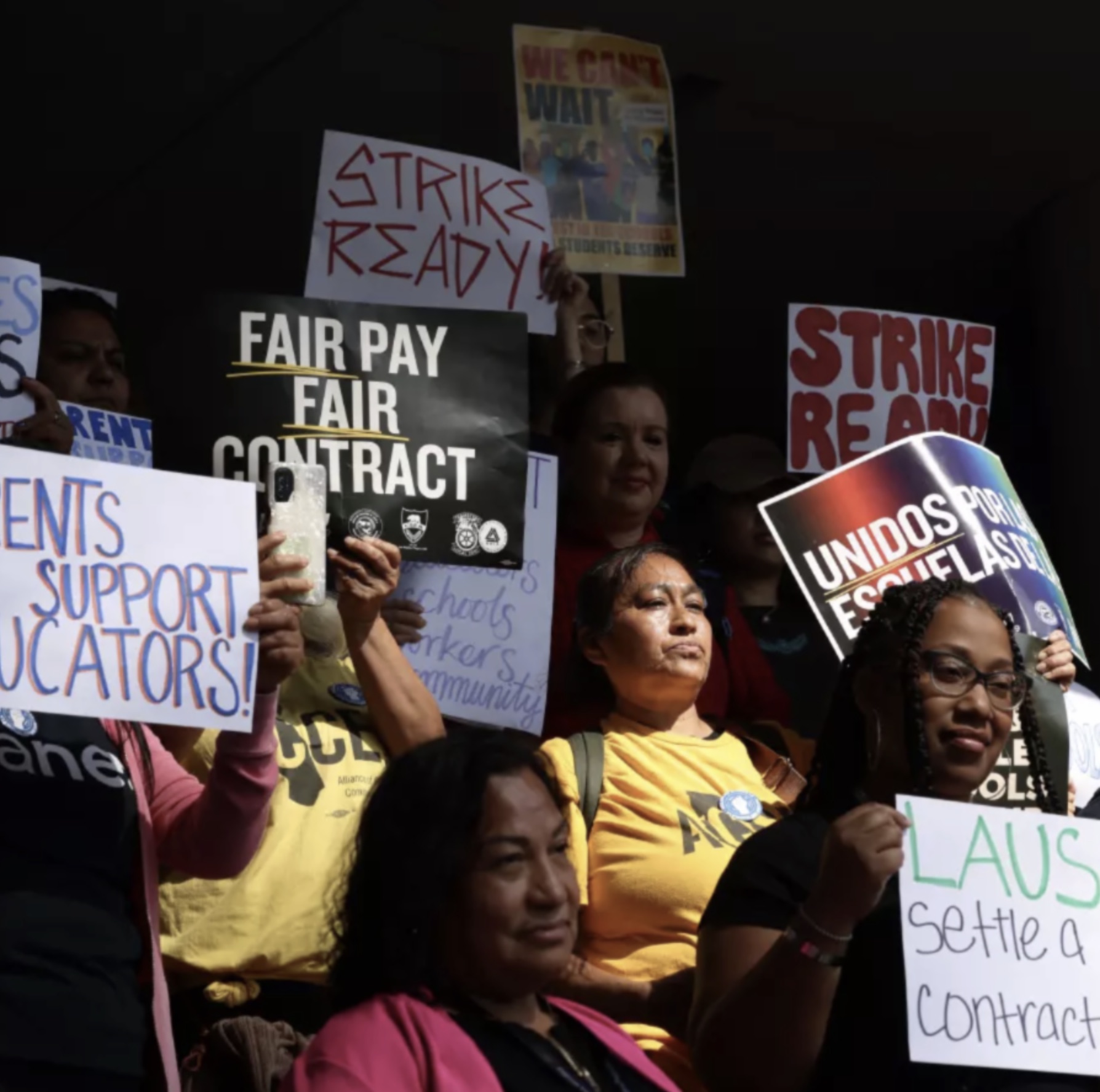 People protesting and holding up signs